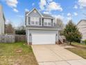 Well-maintained two-story home featuring a spacious driveway, manicured lawn, and beautiful architectural details at 3809 Mardela Spring Dr, Raleigh, NC 27616