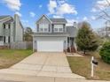 Two-story home with an attached garage, a neatly kept lawn, and a welcoming front entrance at 3809 Mardela Spring Dr, Raleigh, NC 27616
