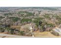 Stunning aerial view of the home nestled in a serene wooded setting with a pond at 4200 Us 1 Highway South, Kittrell, NC 27544