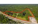 Acreage featuring mature trees and pond, outlined in red to show property lines at 4200 Us 1 Highway South, Kittrell, NC 27544
