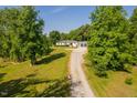White home with an attached garage, complemented by a lush lawn and long driveway at 4200 Us 1 Highway South, Kittrell, NC 27544