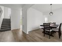 Open dining area with wood-look floors, with views to the stairs and the home's entrance at 5332 Seaspray Ln, Raleigh, NC 27610