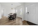 Bright dining area with wood floors and a stylish light fixture, perfect for Gathering meals at 5332 Seaspray Ln, Raleigh, NC 27610