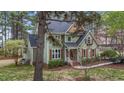 Traditional home with gabled roof, wood shutters and trim, lush landscaping, and a tree-lined property at 5504 Quails Call Ct, Garner, NC 27529