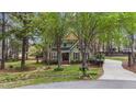 Two-story home with wood shutters and trim, gabled roof, mature trees, and private driveway at 5504 Quails Call Ct, Garner, NC 27529