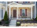 Inviting covered porch with brick facade and space for outdoor seating at 5917 Kayton St, Raleigh, NC 27616