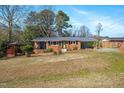 Charming brick home featuring a carport, front porch and a well-maintained front yard at 608 N 15Th St, Erwin, NC 28339