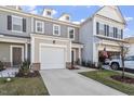 Attractive townhome featuring a one-car garage, neutral siding, and a well-maintained lawn at 63 Pale Moss Dr, Clayton, NC 27527
