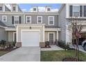 Inviting townhome with a well-manicured lawn and a convenient garage, blending comfort and curb appeal at 63 Pale Moss Dr, Clayton, NC 27527