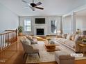 Bright, staged living room features a fireplace, ceiling fan, and French doors leading to the outside at 6624 Professor St, Raleigh, NC 27616
