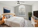 Spacious bedroom featuring a ceiling fan, large window and staged furniture at 6624 Professor St, Raleigh, NC 27616