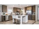 Modern kitchen features a central island, stainless steel appliances, and stylish light fixtures at 6646 Woodlawn Dr, Oxford, NC 27565