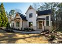 Charming two-story home with manicured landscaping, featuring a welcoming entrance and a blend of siding and brick at 6816 Rainwater Rd, Raleigh, NC 27615