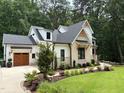 Beautiful home featuring manicured landscaping, a side-entry garage, and a well-maintained lawn at 6816 Rainwater Rd, Raleigh, NC 27615