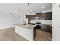 Modern kitchen boasts stainless steel appliances, granite counters, and a central island at 88 Ripple Way # 314, Clayton, NC 27520