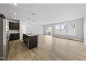 Open-concept kitchen featuring an island that connects to a bright, spacious living area at 88 Ripple Way # 314, Clayton, NC 27520