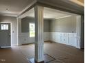 Bright living room featuring decorative columns and stylish wainscotting at 896 Olive Branch Dr, Smithfield, NC 27577