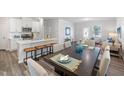 Inviting dining area with a modern table setting and open access to the kitchen at 1007 Sora Way, Durham, NC 27703