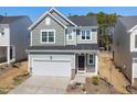 Charming two-story home with a well-maintained lawn and attached two car garage at 1007 Sora Way, Durham, NC 27703