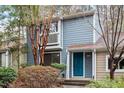 Charming two-story home with a blue exterior, a small balcony, and mature landscaping at 1016 N Bend Dr, Raleigh, NC 27609