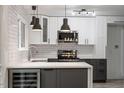 Modern kitchen with white cabinets, stainless steel appliances, and stylish pendant lighting at 1016 N Bend Dr, Raleigh, NC 27609