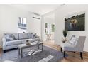 Inviting living room with stylish gray furniture, bright light, a modern rug and hardwood floors at 1031 W Murray Ave, Durham, NC 27704