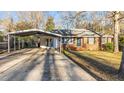 Lovely single-story brick home with a covered carport and well-maintained lawn at 104 Seaman St, Oxford, NC 27565
