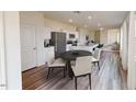Bright dining area adjacent to the kitchen, featuring modern furnishings and luxury vinyl plank flooring at 1153 Solace Way, Rolesville, NC 27571