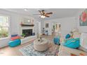 Airy living room with a white brick fireplace, plush seating, and decorative rug at 1208 Turner Farms Rd, Garner, NC 27529