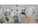 Inviting living room featuring a brick fireplace, neutral sofa, and lots of natural light at 1208 Turner Farms Rd, Garner, NC 27529