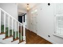 Welcoming entryway with hardwood floors, staircase, and entry door at 1222 Dixie Trl, Raleigh, NC 27607