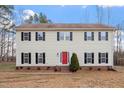 Traditional two-story home with a red front door, black shutters and symmetrical windows at 125 Vance Wrenn Rd, Roxboro, NC 27573