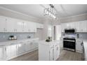 Bright kitchen featuring white cabinets, stainless steel appliances, and a stylish island at 125 Vance Wrenn Rd, Roxboro, NC 27573