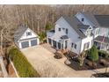 Aerial view of a lovely home featuring an expansive driveway and three-car garage at 1412 Wynncrest Ct, Raleigh, NC 27603