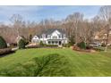 Beautifully landscaped two-story home with a lush green lawn and mature trees at 1412 Wynncrest Ct, Raleigh, NC 27603