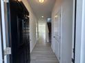 View of the entryway with a black front door and light gray wood-look flooring at 184 Bruce Dr, Dunn, NC 28334