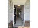 View of the light and airy entryway with light wood floors and a black front door at 184 Bruce Dr, Dunn, NC 28334