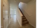 Hallway view with a staircase and light gray wood-look flooring at 184 Bruce Dr, Dunn, NC 28334