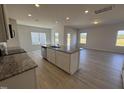 Open-concept kitchen featuring a large island with granite countertops and stainless steel appliances at 184 Bruce Dr, Dunn, NC 28334