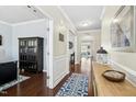 Inviting entryway showcasing hardwood floors, elegant trim, and stylish decor leading into the home at 1912 Pennypacker Ln, Durham, NC 27703