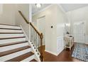 Staircase featuring hardwood steps, a decorative railing, and a view into the home's entryway at 1912 Pennypacker Ln, Durham, NC 27703
