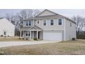 Beautiful two-story home boasting a two-car garage, a lovely covered porch, and a well-maintained lawn at 2121 Wildwind Dr, Graham, NC 27253