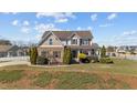 Inviting two-story home with a landscaped front yard and charming covered porch with traditional design elements at 22 Old York Cir, Clayton, NC 27527