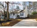 Quaint home with a welcoming front porch, freshly mulched landscaping, and a well-maintained exterior at 224 Round About Rd, Holly Springs, NC 27540
