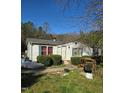 Modest single-story house with minimal landscaping and signs of neglect scattered across the yard at 2383 Egypt Mountain Rd, Kittrell, NC 27544