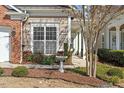 Inviting exterior with manicured landscaping and a birdbath, complemented by stylish siding and brick accents at 241 Lifeson Way, Cary, NC 27519