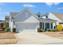 Attractive single-Gathering home featuring a spacious two-car garage, dormer windows, and manicured front yard at 2436 Fiddich Ln, Fuquay Varina, NC 27526