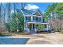 Beautiful two-story home with a charming front porch and classic design elements at 4001 Gatewood Falls Ct, Apex, NC 27539