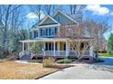 Inviting home with a covered porch, showcasing its classic architecture and curb appeal at 4001 Gatewood Falls Ct, Apex, NC 27539