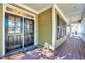 Charming covered front porch featuring a stylish door and ample space for relaxation at 4001 Gatewood Falls Ct, Apex, NC 27539